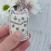 Cute Bride cat ornament wearing a drawn on wedding dress and a lace veil with pink sewn on beads