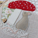 Mouse under a toadstool hoop art.