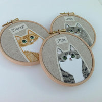 textile cat portraits framed in wooden embroidery hoops